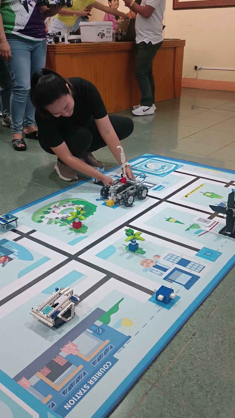 Kat Hervera testing a mobile robot on a robotics challenge field